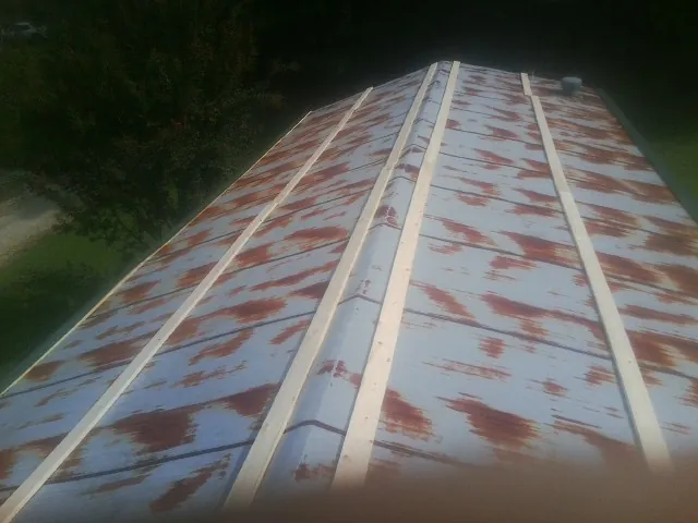 Rusted metal roof panels with new wood purlins before replacement — Storm Damage Roof Repair in Ripon by Roofing Brothers