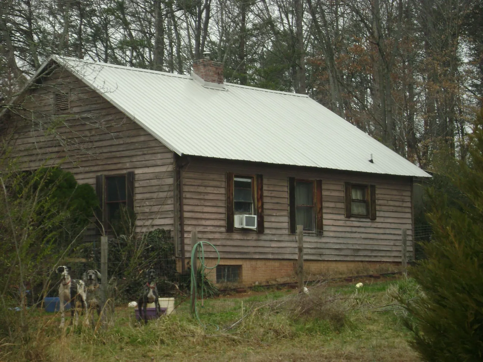 White metal roof on an old wood sided farmhouse, from a Metal Roof Installation job in Ripon